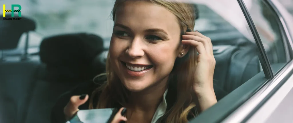 “Happy customer enjoying a safe taxi den haag trip in a modern car”